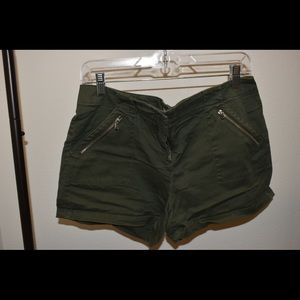 BRAND NEW Dark Green Tailored Flat Front short with gold zipper accented detail.